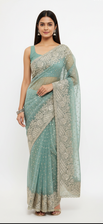 Woman wearing a light blue saree with a white background